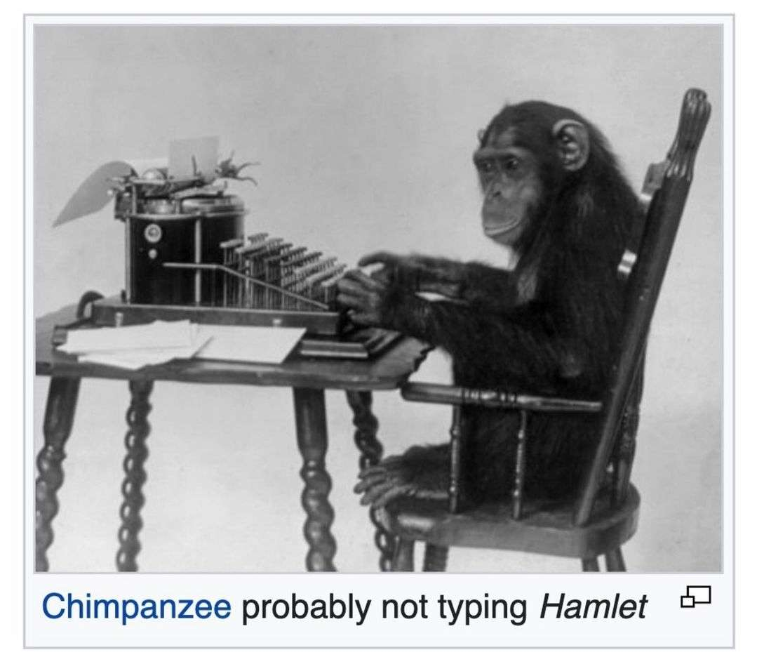 A black and white photograph shows a chimpanzee sitting in a wooden chair at a desk, its hands resting on the keys of a vintage typewriter. The chimpanzee gazes forward with a neutral expression. Below the image is the caption: "Chimpanzee probably not typing Hamlet."